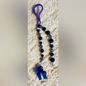 Handmade Glass octopus with metal cross keychain.